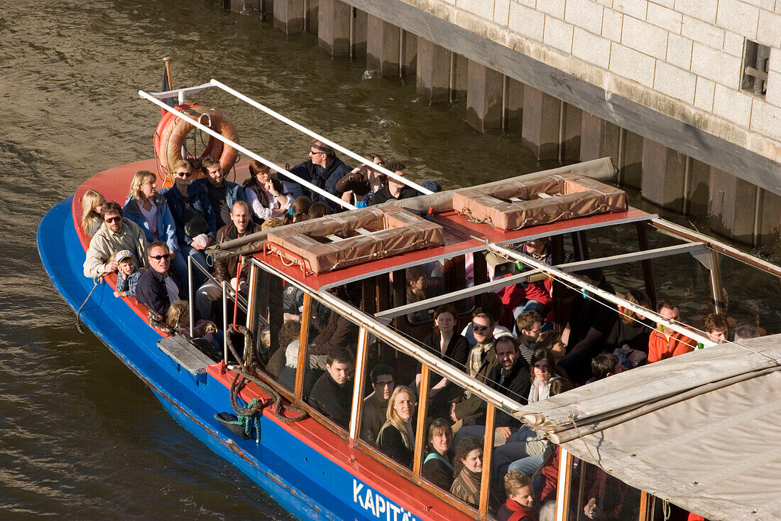 People sitting in a barge, harbor tour, Hamburg, Germany
