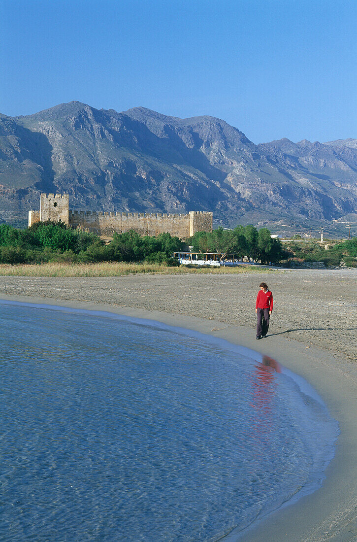 Woman walking on beach, Castle, Frangokastello, Crete, Greece