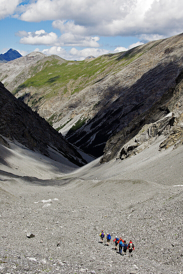Medium group of hikers in a scree valley, Val Sassa, Swiss Nationalpark, Engadin, Graubuenden, Grisons, Switzerland, Alps