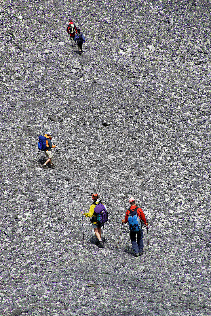Hikers in a valley full of scree, Val Sassa, Swiss Nationalpark, Engadin, Graubuenden, Grisons, Switzerland, Alps