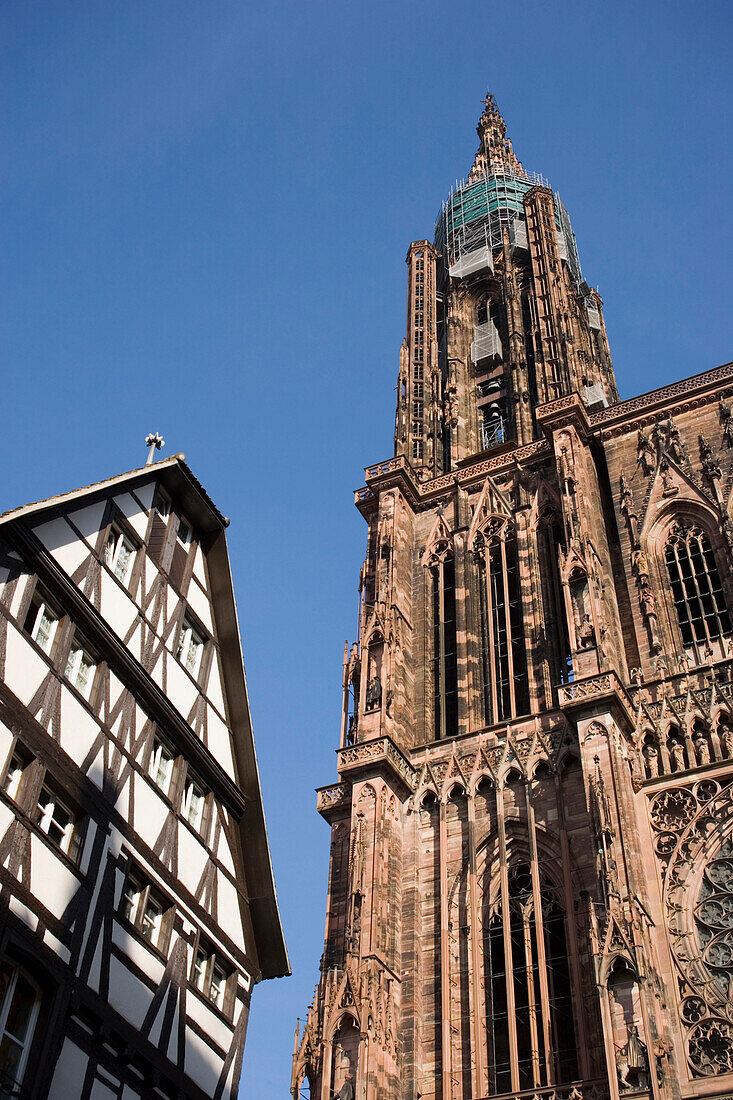 View to a timbered house and Our Lady's Cathedral, View to a timbered house and the west facade with spire of Our Lady's Cathedral Cathedrale Notre-Dame, , Rue Merciere, Strasbourg, Alsace, France