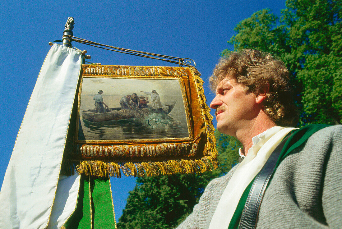 Mid adult man at procession, Corpus Christi, Chiemsee, Bavaria