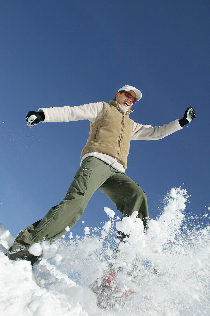 Young woman having fun in winter landscape