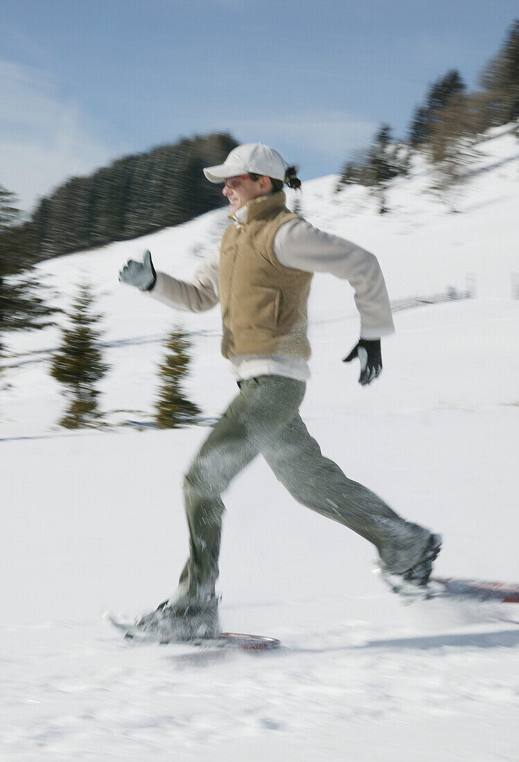 Young woman running in winter landscape