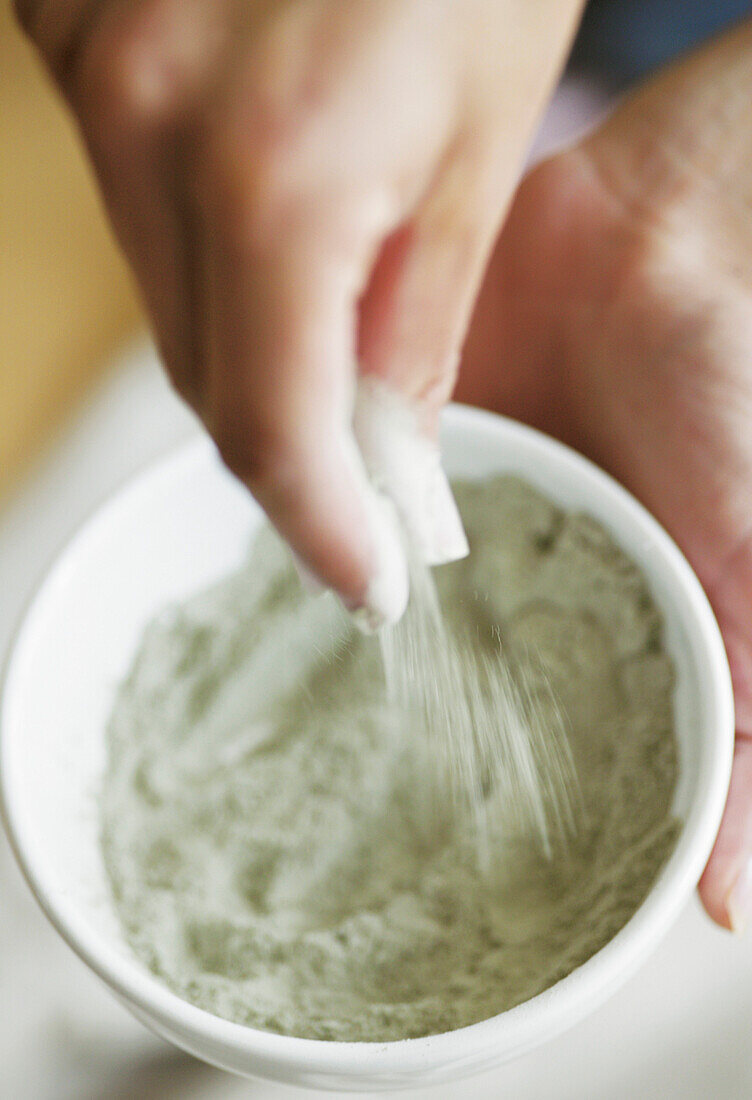 Female hands with clay for body care