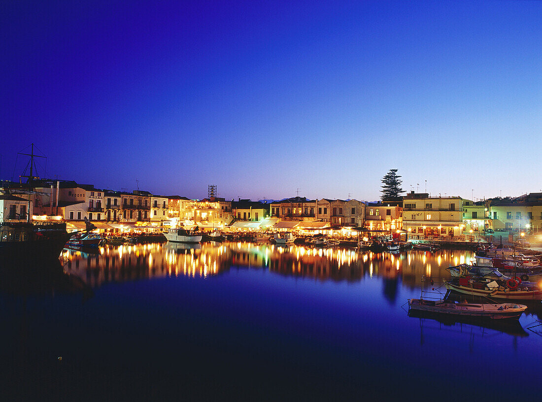 Venetian Harbour at night with restaurants, Réthimnon, Crete, Greece