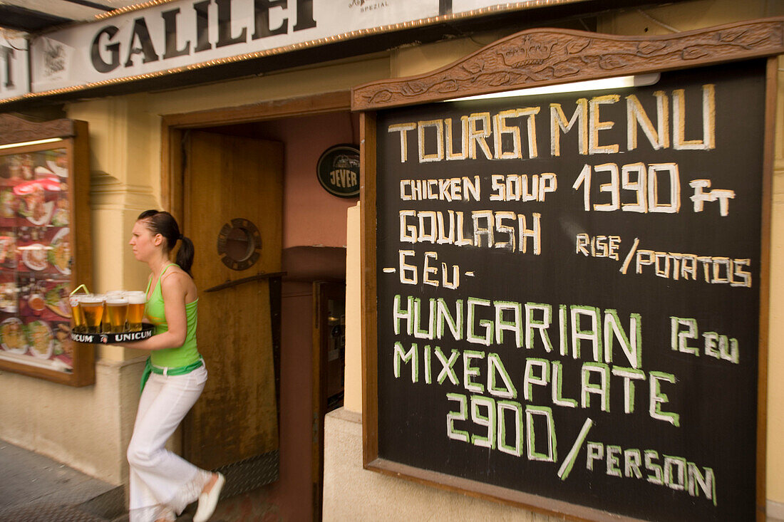 Waitress serving beer, Waitress serving beer in an open-air restaurant at Vaci Street, Pest, Budapest, Hungary
