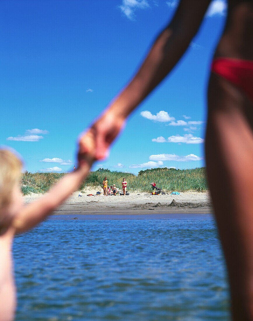 Girl holding mothers hand