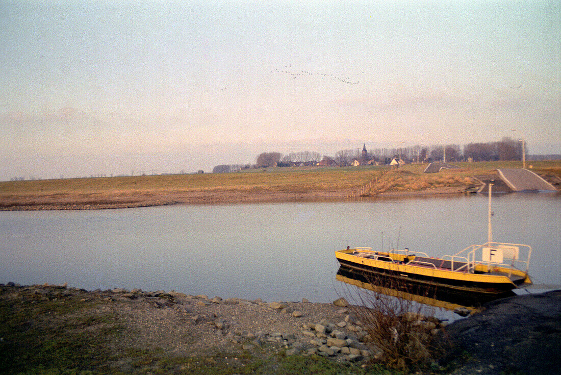 Ferry on a river at afterglow, North Rhine-Westphalia, Germany