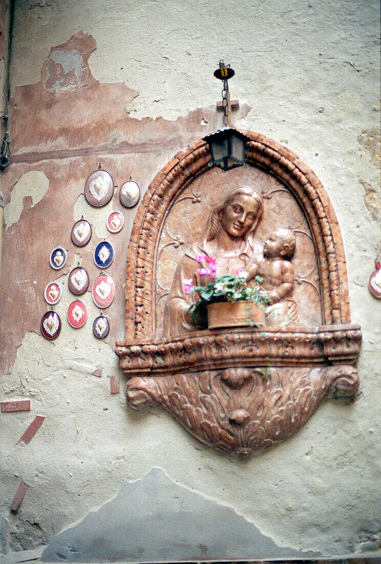 Figure of Virgin Mary on wall, Verona, Italy