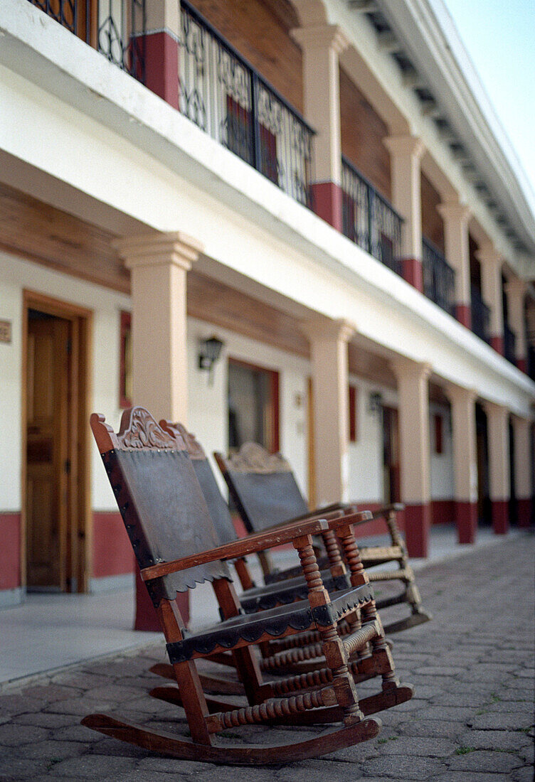 Rocking chairs on empty street, Creel, Chihuahua, Mexico