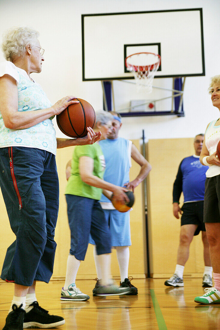 Mature People playing basketball