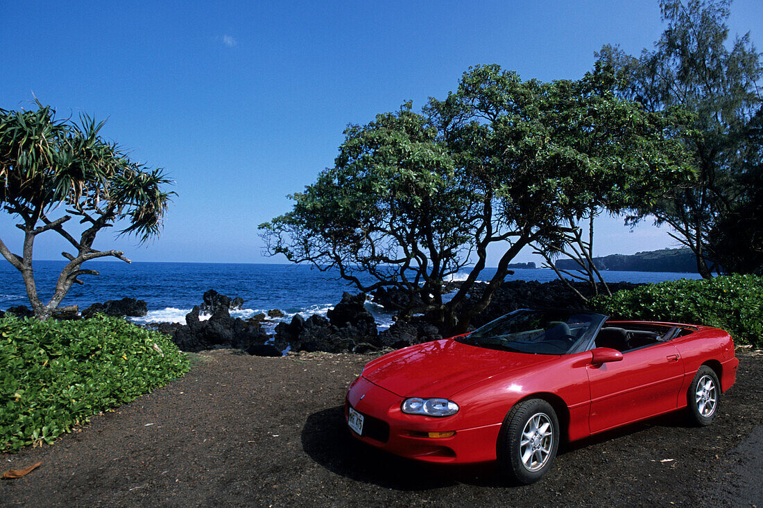 Red Convertible on Coastline, Road to Hana, Near Keanae, Maui, Hawaii, USA