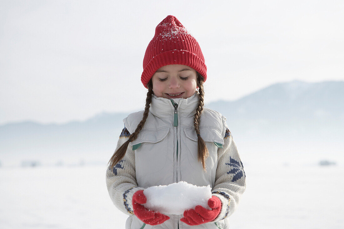 Girl 5-6 Years, holding snow in hands