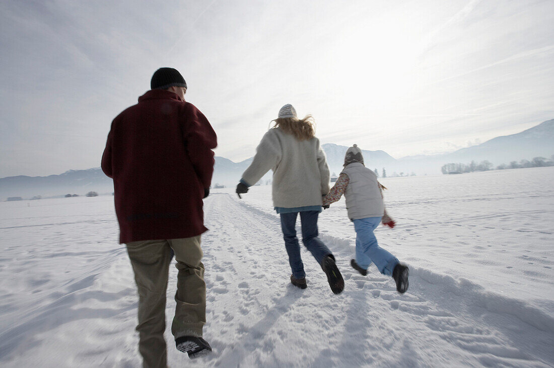 Family is running in the snow