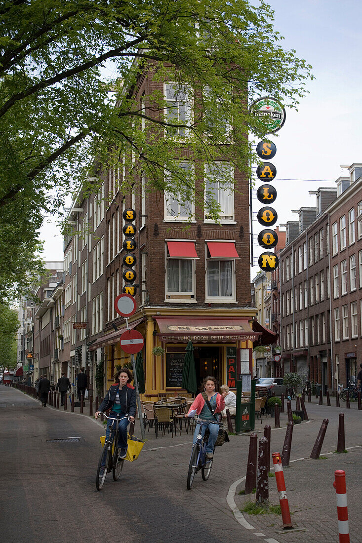 Cyclists, Houses, Bicycles near Leidesplein, restaurant in background, Amsterdam, Holland, Netherlands