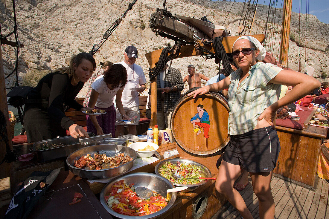 People using buffet on a sailing boat during a trip to a bay at Kalymnos, Greece