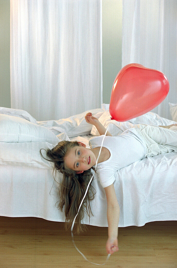 Girl holding red ballon