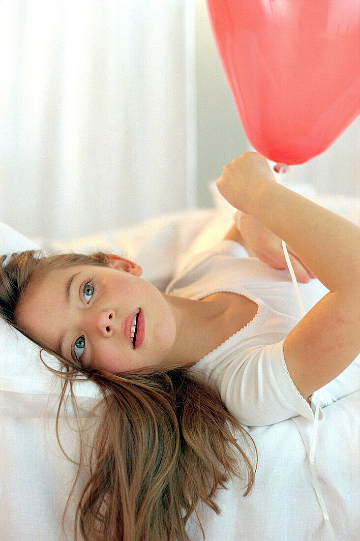 Girl holding red ballon, portrait