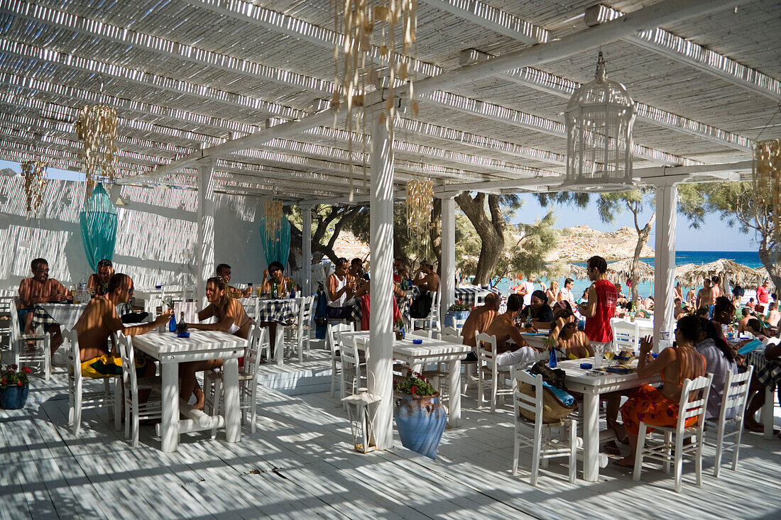 People sitting in the beach bar at the Paranga Beach, Mykonos, Greece