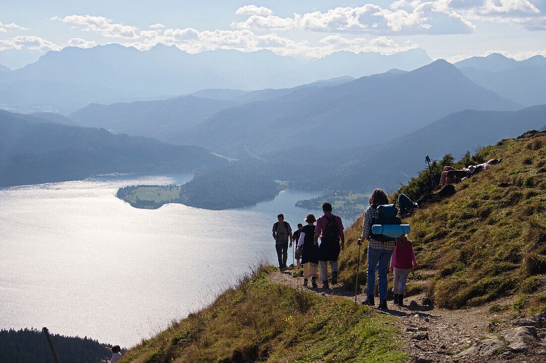Medium group of people hiking from Jochberg to Lake Walchensee, Upper Bavaria, Germany
