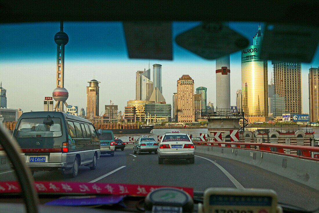 Traffic Shanghai,taxi, driver, expressway to Bund, skyline Pudong, view through windscreen
