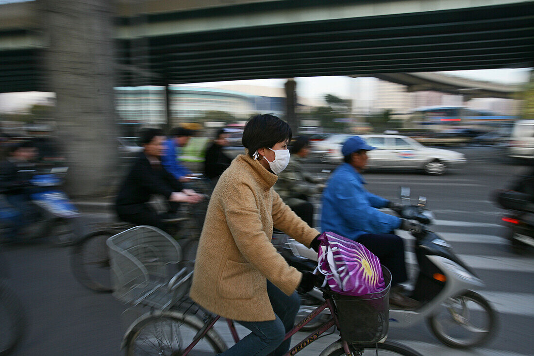 Traffic Shanghai,Fahrradfahrerin mit Mundschutz, bicyclist, breathing mask, face-mask, elevated motorway, junction