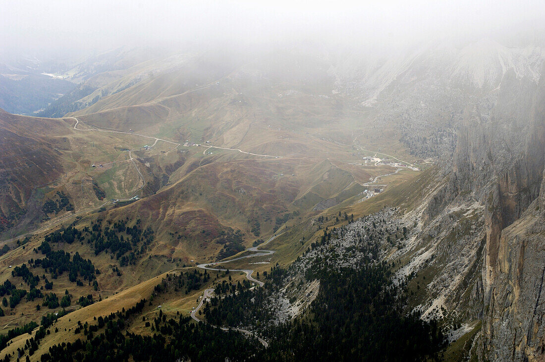 View through clouds at barren mountain scenery, Dolomites, Italy