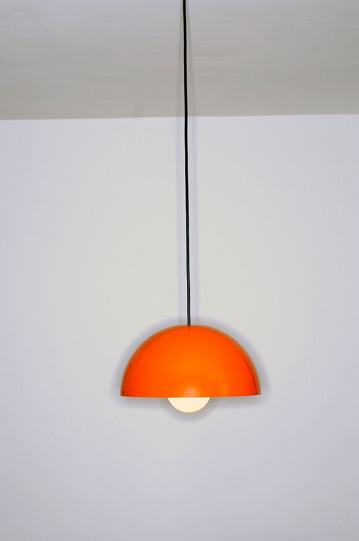 Orange 1970s style ceiling light in empty livingroom