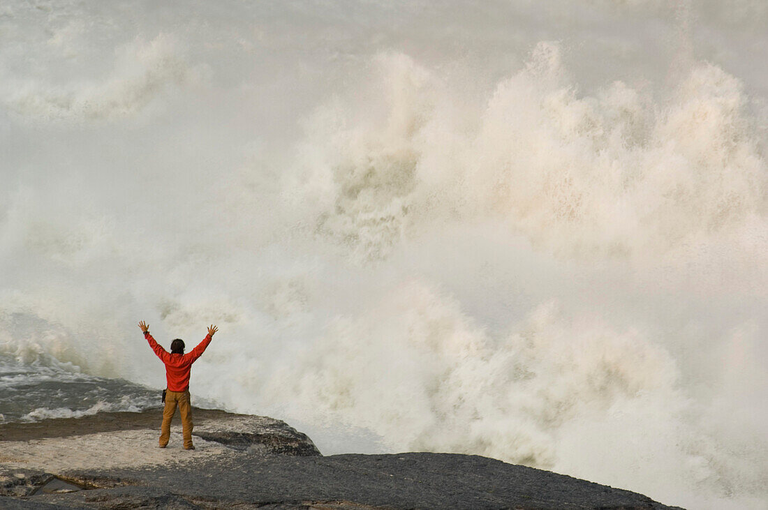 Man standing in front of Virginia Falls, Northwest Territories, Canada