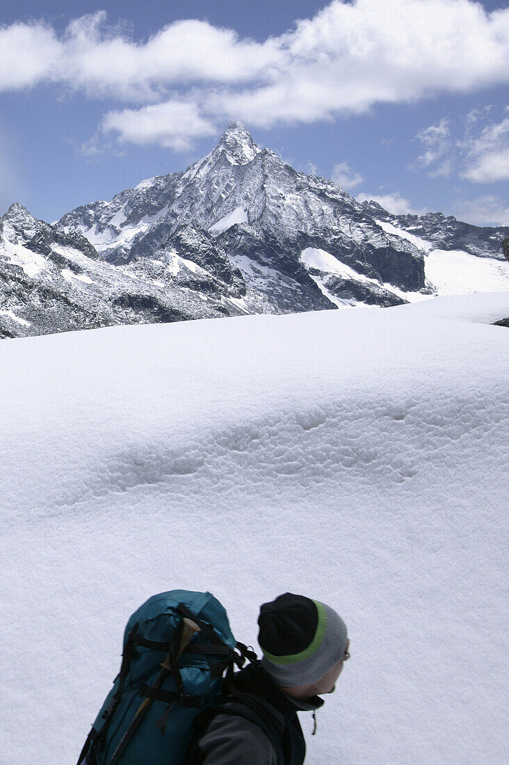 Hiker looking at view, Passo Cameraccio, Monte Disgrazia, Bregaglia Mountains, Italy