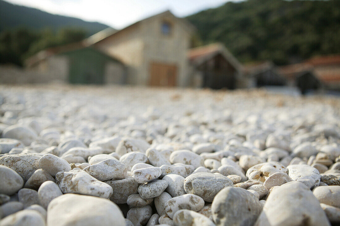 Pebble Beach with boat houses, Port Beli, Cres Island, Croatia