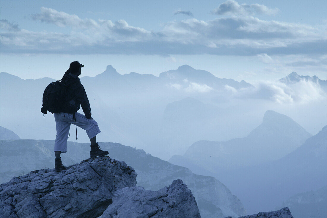 Hiker looking at mountains, Cristallo Group,  Dolomites ,Veneto, Italy