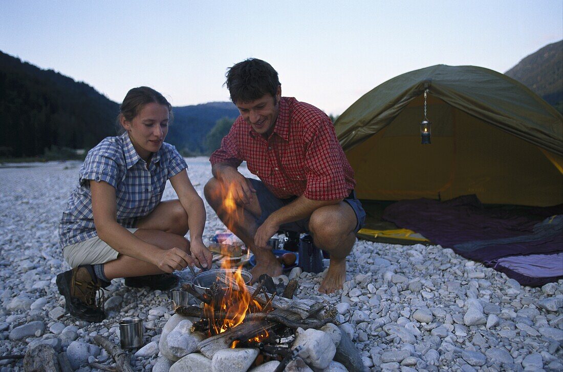 Couple at campfire, camping, Sylvenstein See, Bavaria, Germany, Europe