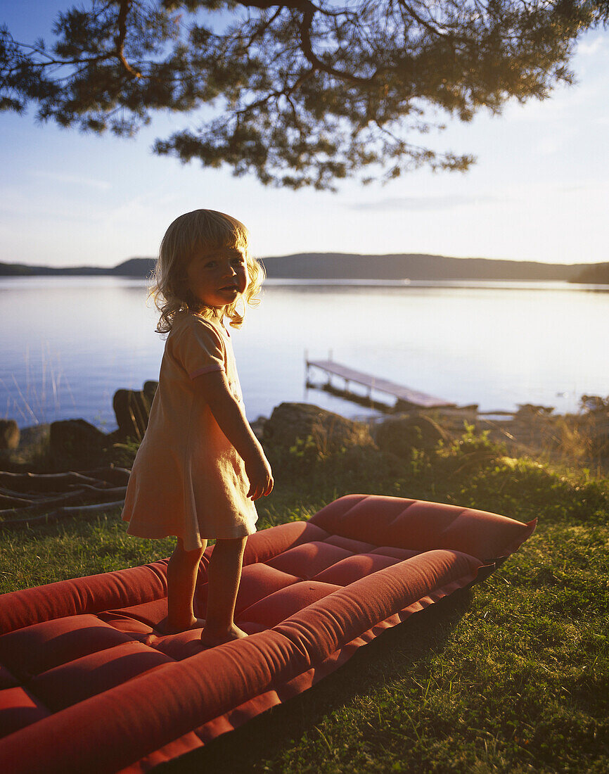 Little girl standing on air bed