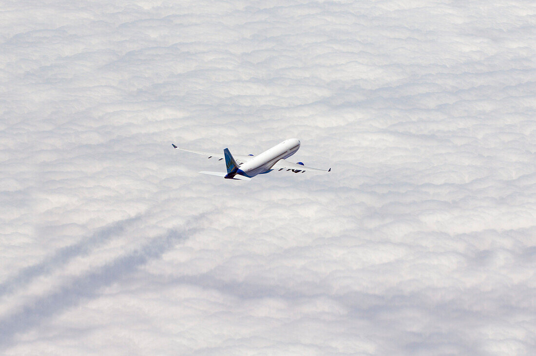 Airplane flying over sea of clouds