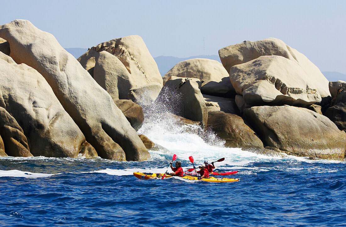 Seakayaking in front of rockcliffs, Punta Porticcio, Gulf of Ajaccio, Mediterranean Sea, Corsica, Corsica Raid, France