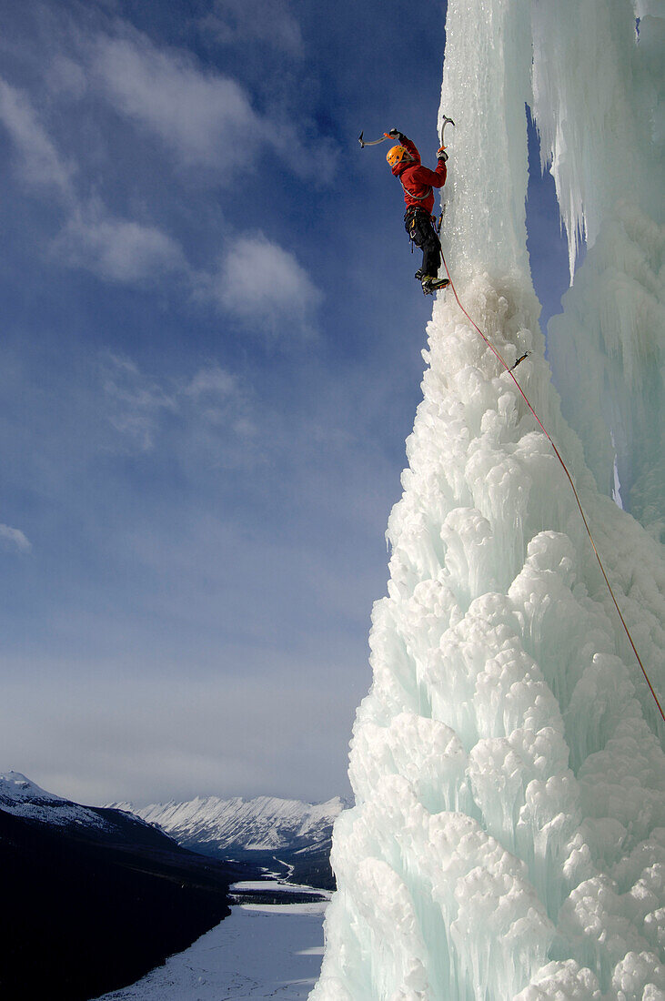 Male ice climber ascending ice, Curtain Call, British Columbia, Canada