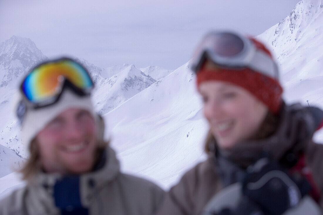 Young couple holding snowboards, portrait, Kuehtai, Tyrol, Austria