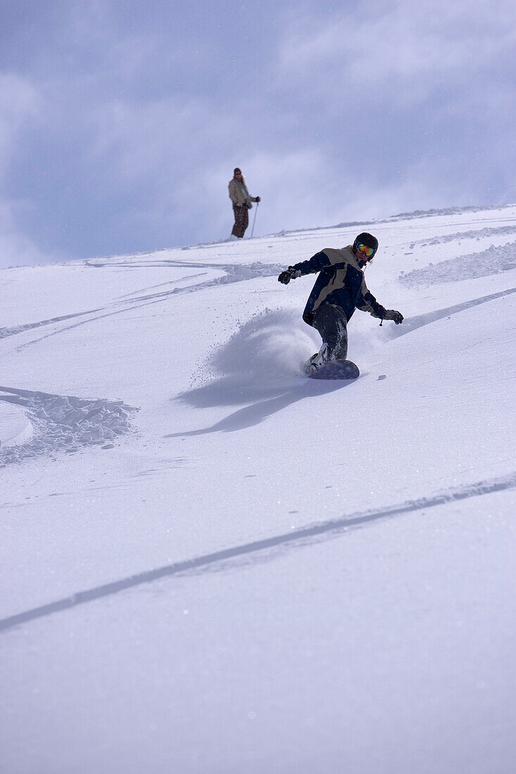 Snowboarding on mountain slope, Kuehtai, Tyrol, Austria
