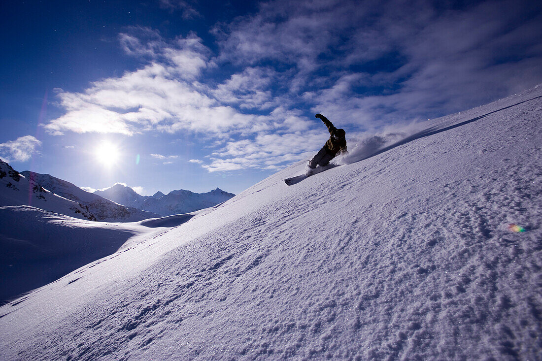 Snowboarding moving down in powder snow, Kuehtai, Tyrol, Austria