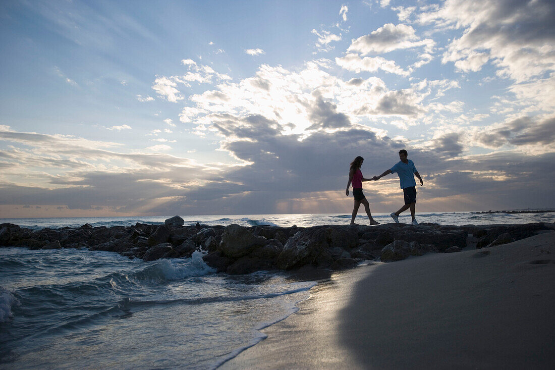 Couple walking on beach, evening mood, Apulia, Italy