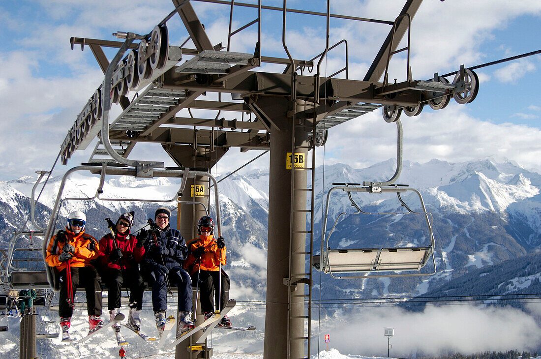 A group of skiers sitting on a chair lift, Bad Gastein, Austria