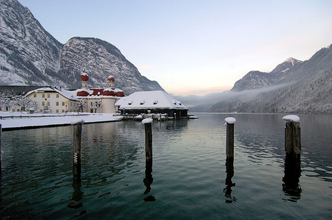 The snow covered pilgrimage church St. Bartholomä on peninsula Hirschau, lake Königssee, Berchtesgardener Land, Bavaria, Germany