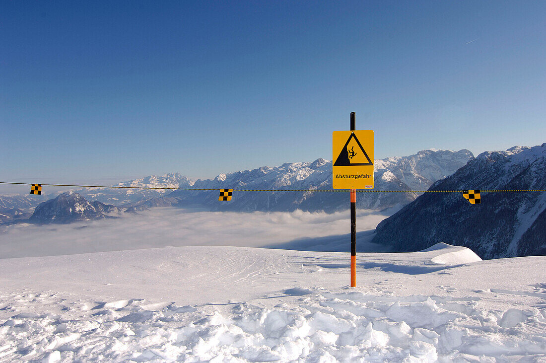 A warning sign in the snow under blue sky, Berchtesgardener Land, Bavaria, Germany