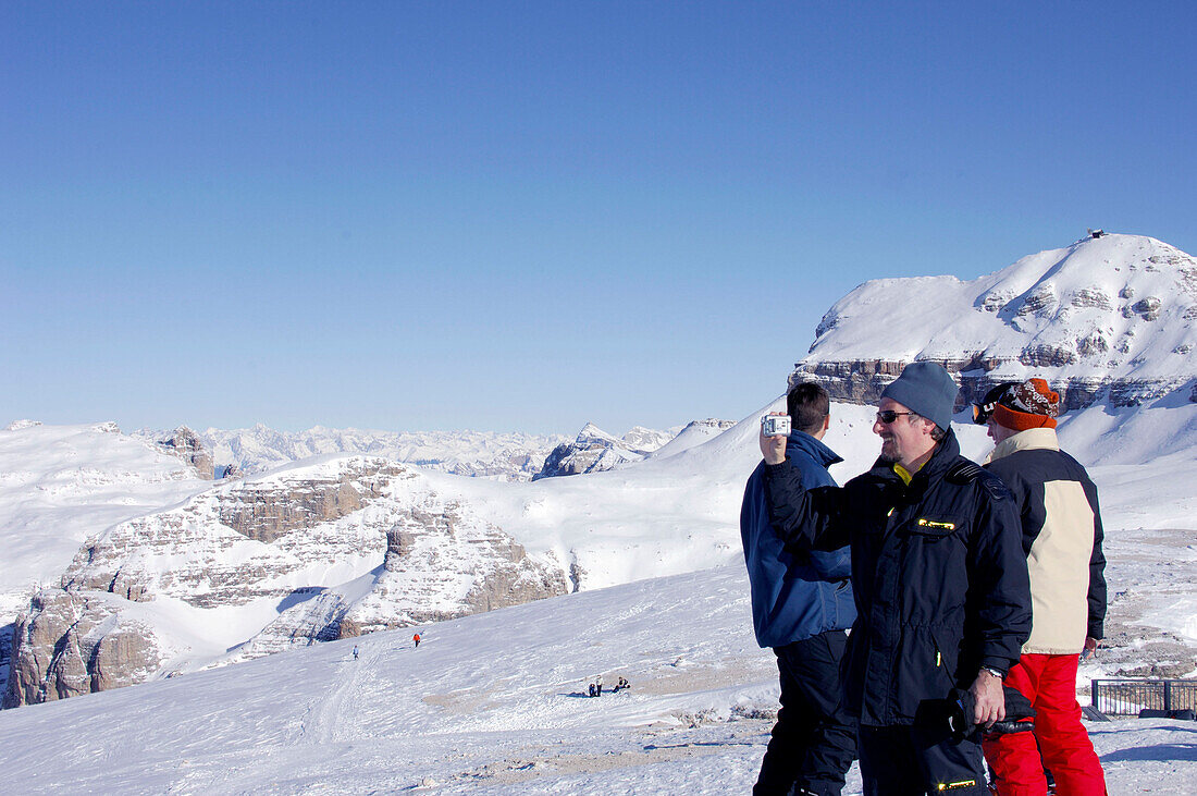 Tourists in snow covered landscape, Passo Pordoi, Dolomites, Italy, Europe