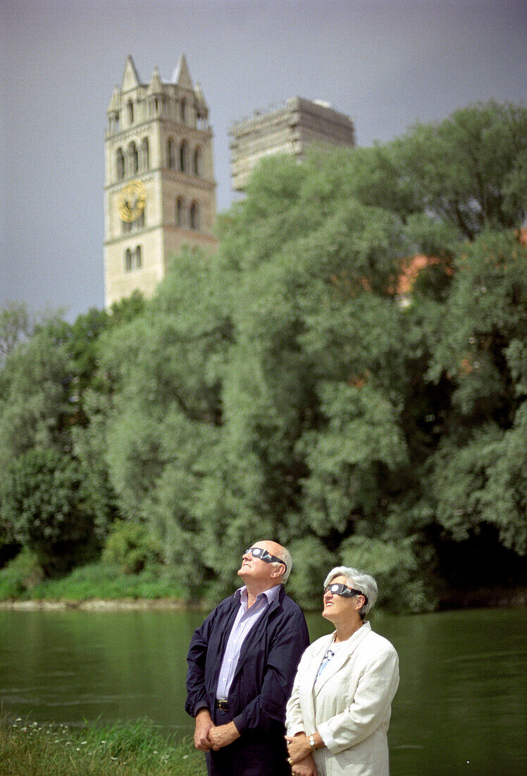 Old couple watching solar eclipse, Munich, Bavaria, Germany