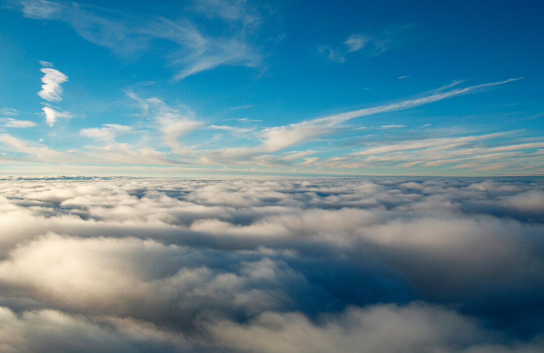 Cloud layer below blue sky