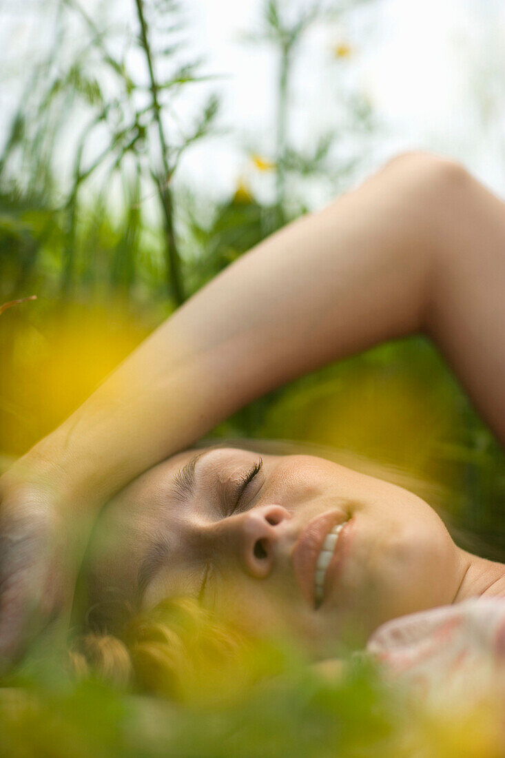 Young woman lying on meadow, close-up