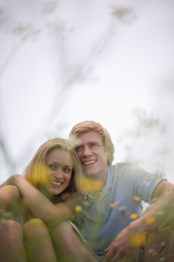 Young couple sitting on meadow